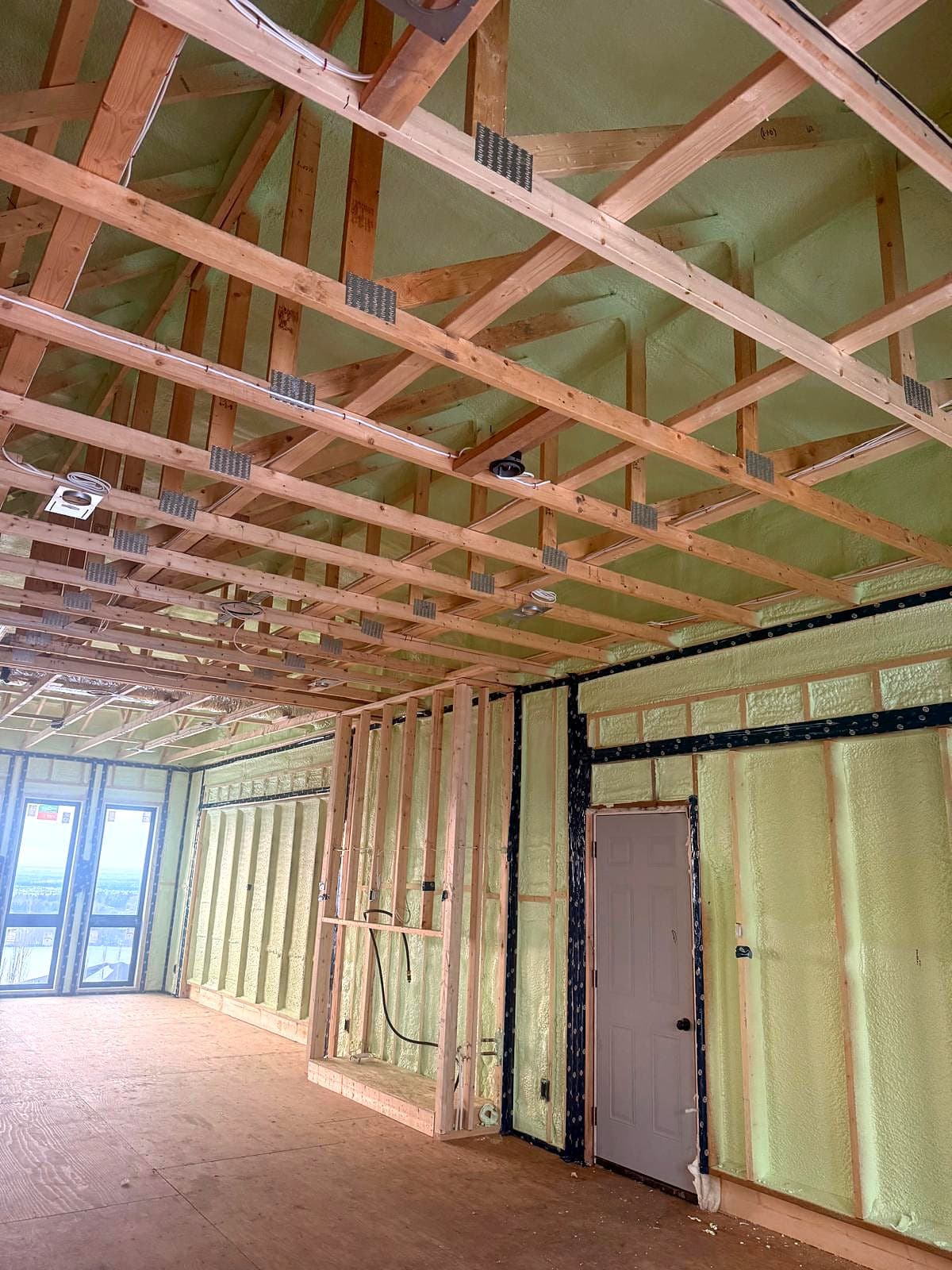 Closed-cell spray foam in a custom home great room Vaulted great room in a new custom home with Genyk Boreal Nature Elite 2 lb closed-cell spray foam on the walls and roof deck
