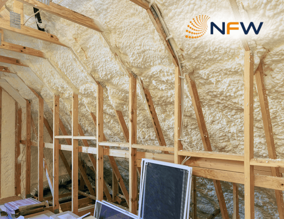 Attic rafters with spray foam insulation Attic rafters coated in cream-coloured spray foam insulation, NFW logo